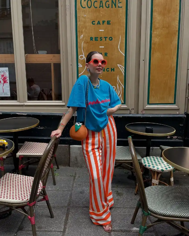 Blue Graphic Tee + Orange Striped Wide-Leg Trousers + Orange Novelty Bag