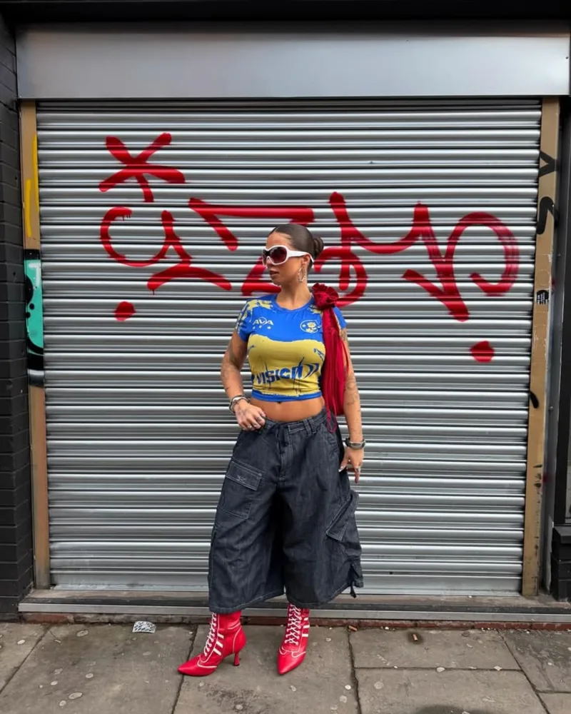 Blue & Yellow Graphic Crop Top + Dark Denim Cargo Bermudas + Red Heeled Boots