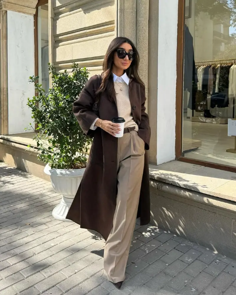 Dark Chocolate Long Coat Over Beige Knit Vest and White Shirt