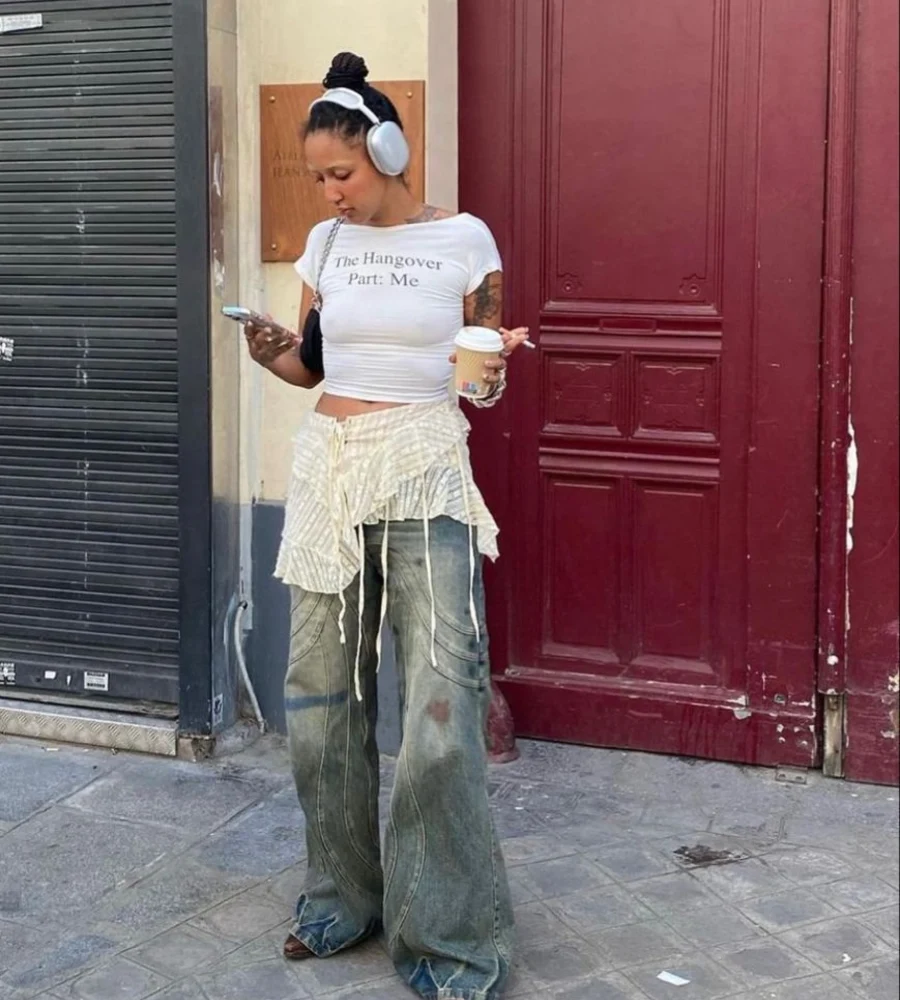Graphic Crop Tee with Fringe Skirt Over Baggy Jeans and Brown Boots