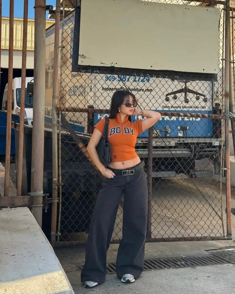 Orange Graphic Crop Polo with Dark Baggy Jeans and Silver Sneakers