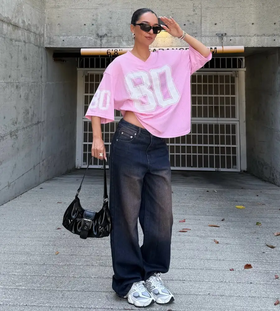 Pink Football Jersey with Dark Baggy Jeans and New Balance Sneakers