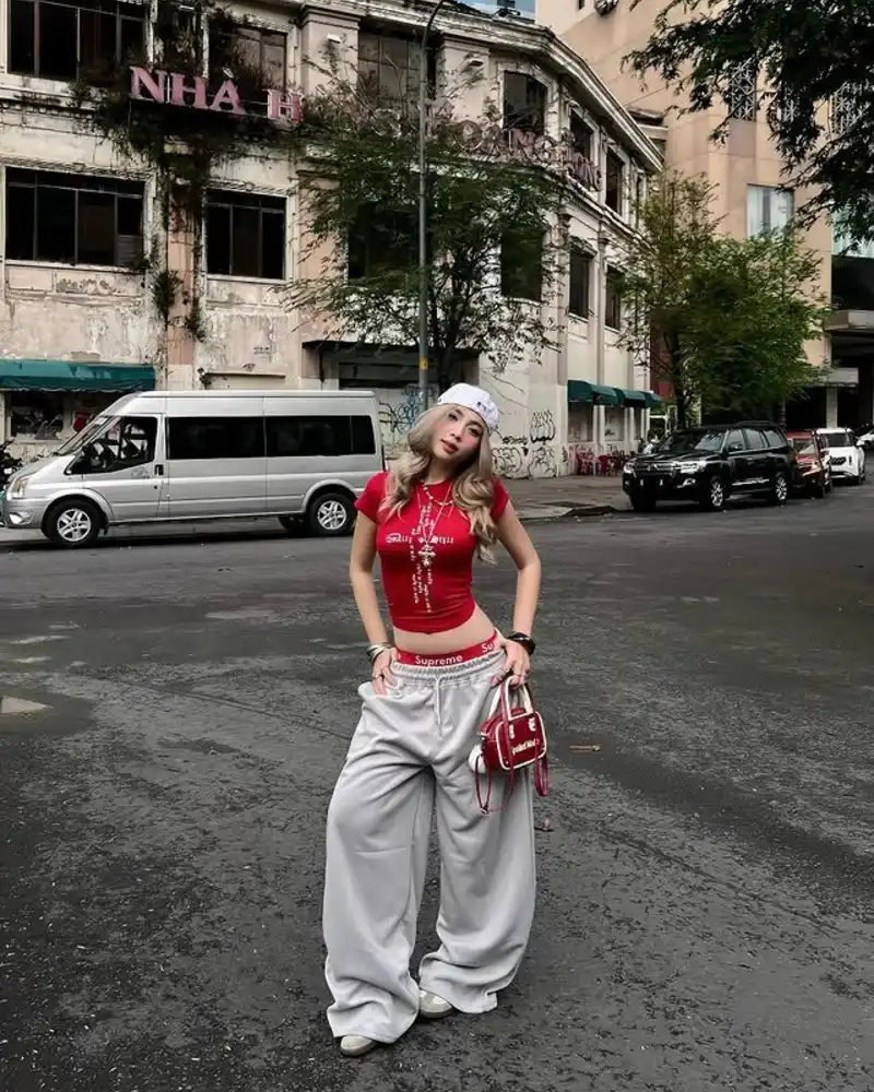 Red Graphic Crop Tee with Grey Supreme Sweatpants, White Cap and Red Mini Bag