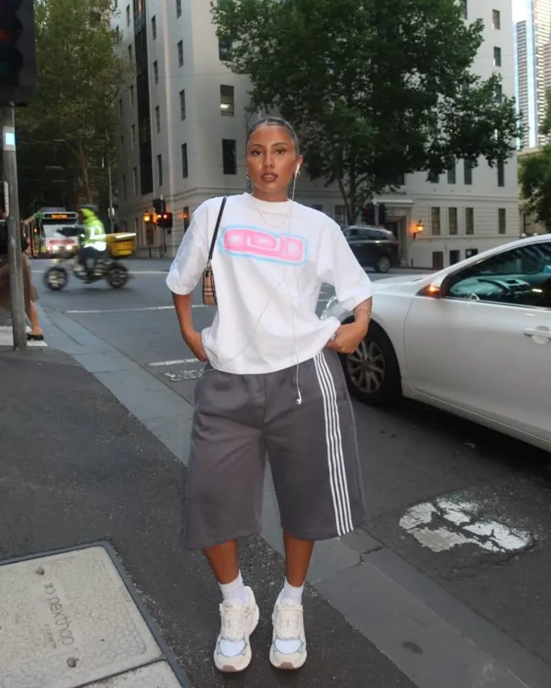 White Oversized Graphic Tee and Grey Wide-Leg Shorts with Chunky Sneakers