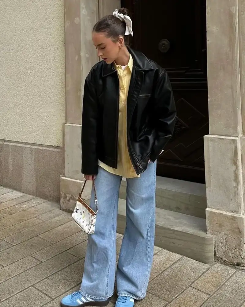 Black Leather Jacket Over a Soft Yellow Shirt