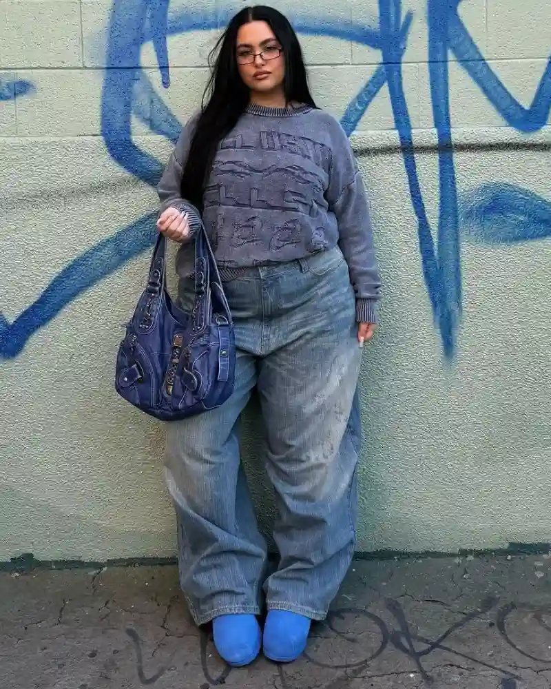 Monochrome Blue Outfit Against a Graffiti Wall