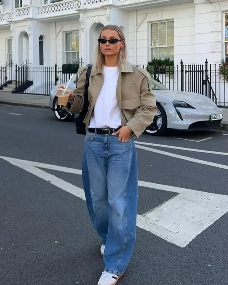 White Tee Under Cropped Tan Trench Jacket and Wide Blue Jeans