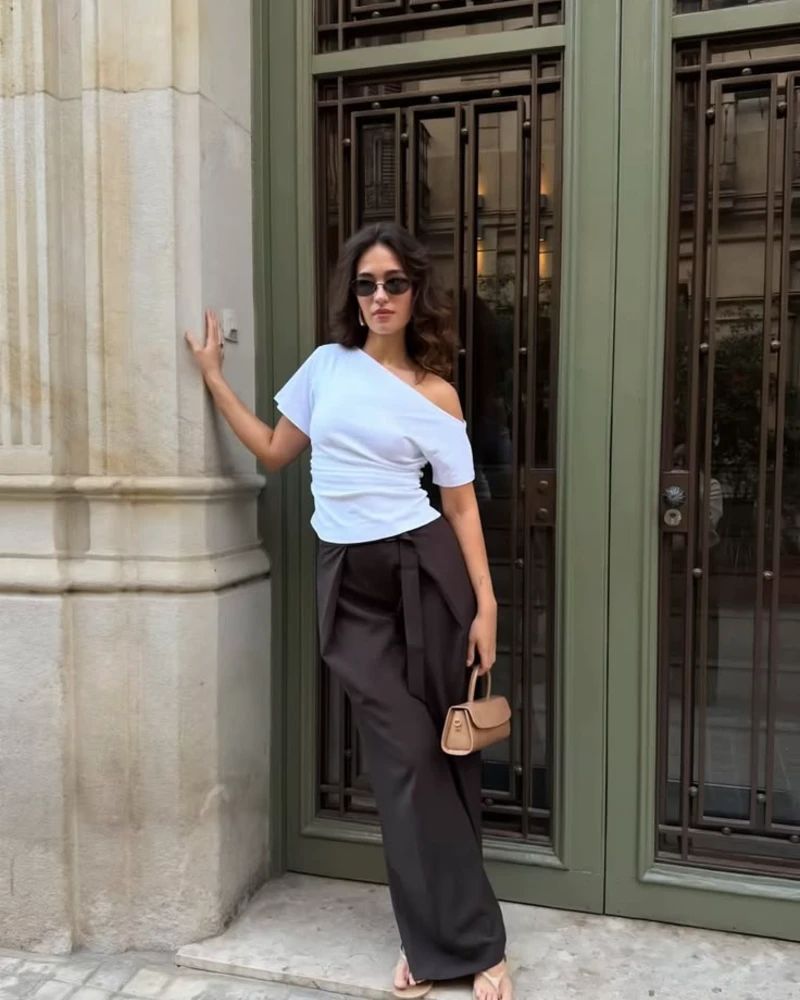 White one-shoulder top, espresso trousers