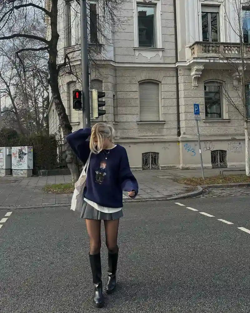 Graphic Crewneck with a Pleated Mini Skirt and Tall Boots