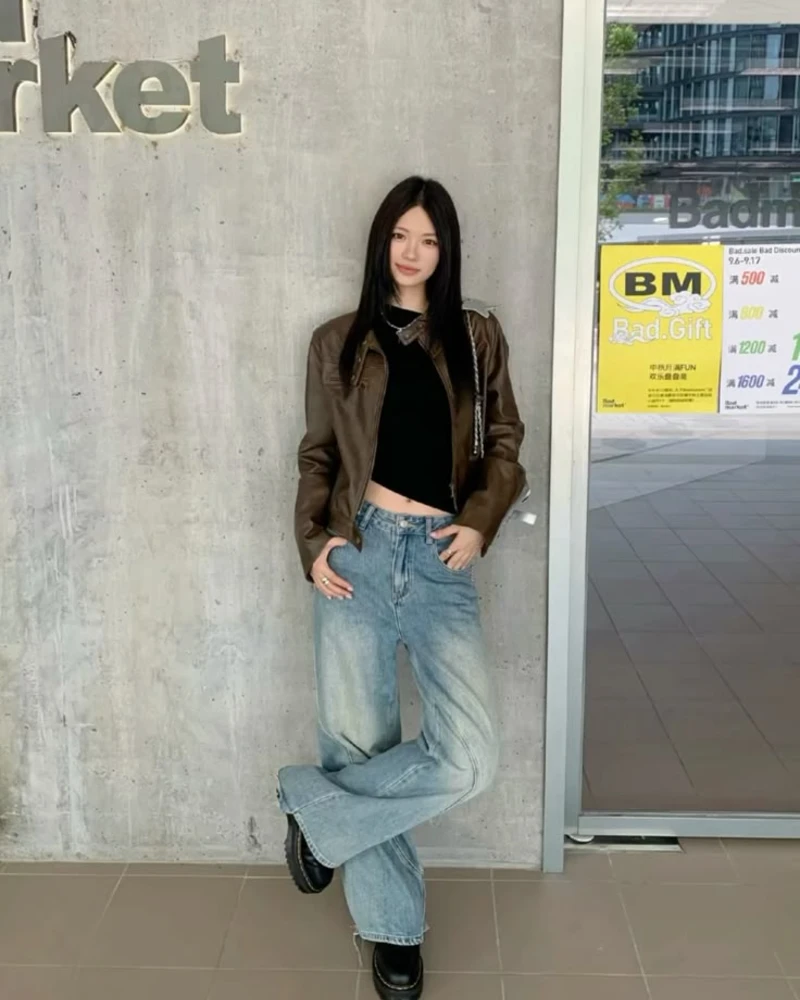 Fitted Black Top With Wide-Leg Jeans and a Brown Leather Jacket