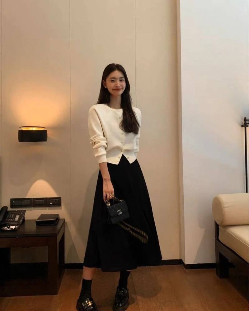 Ivory Cardigan With a Black Midi Skirt