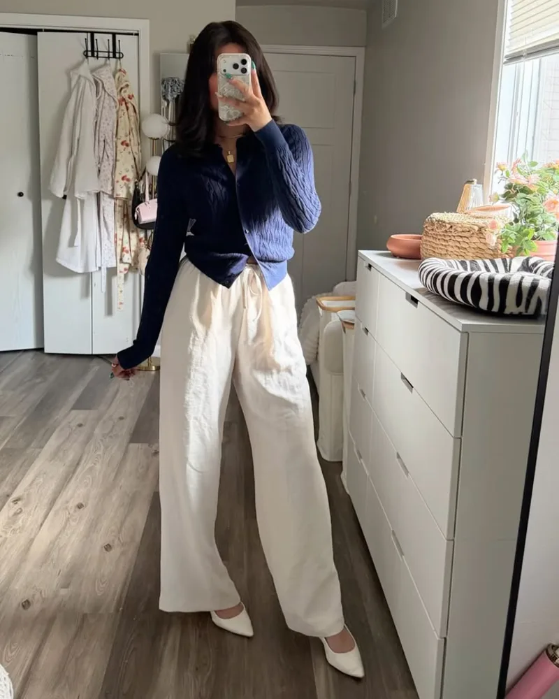 A Navy Cardigan Defines Flowing Ivory Trousers